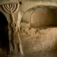 Beth She'arim catacombs, arcosolium and menorah-topped figure